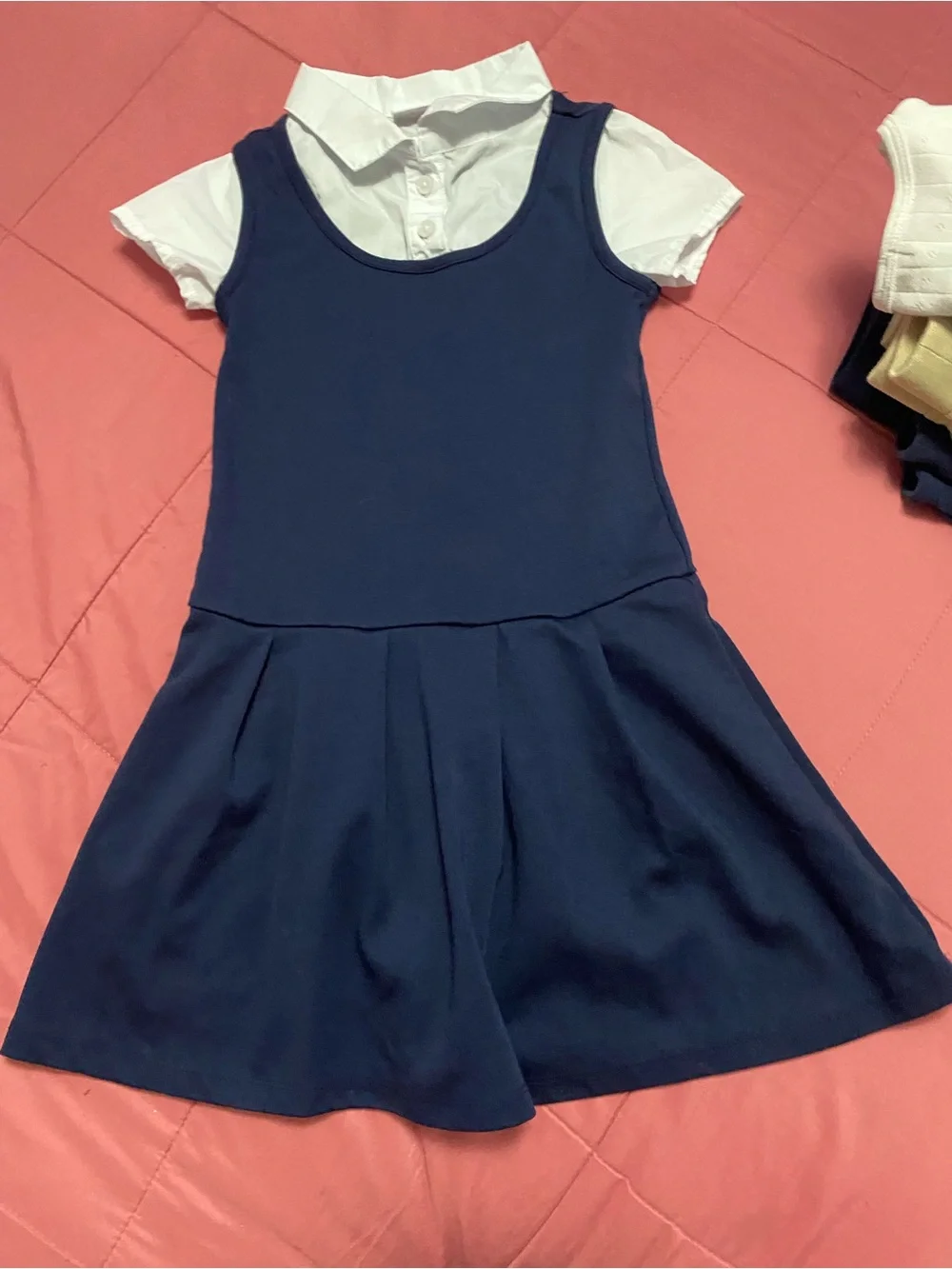 Lot of girl uniforms. Tan navy blue white and red.